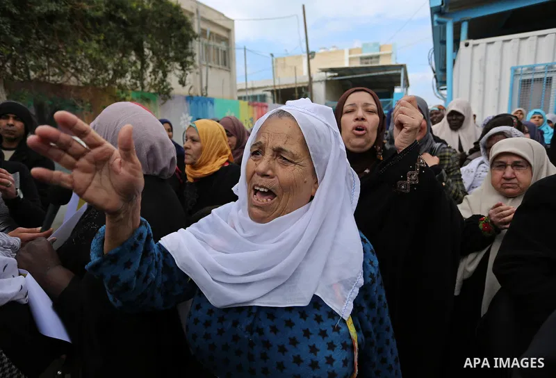 Palestinians take part in a protest against aid cut, in front of the headquarters United Nations Relief and Works Agency (UNRWA) in al-Nusirat refugee camp in the Gaza strip on January 17, 2018 after the White House froz...
