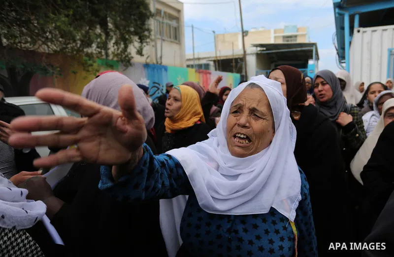 Palestinians take part in a protest against aid cut, in front of the headquarters United Nations Relief and Works Agency (UNRWA) in al-Nusirat refugee camp in the Gaza strip on January 17, 2018 after the White House froz...