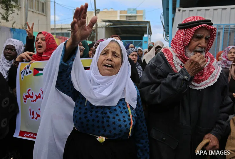 Palestinians take part in a protest against aid cut, in front of the headquarters United Nations Relief and Works Agency (UNRWA) in al-Nusirat refugee camp in the Gaza strip on January 17, 2018 after the White House froz...