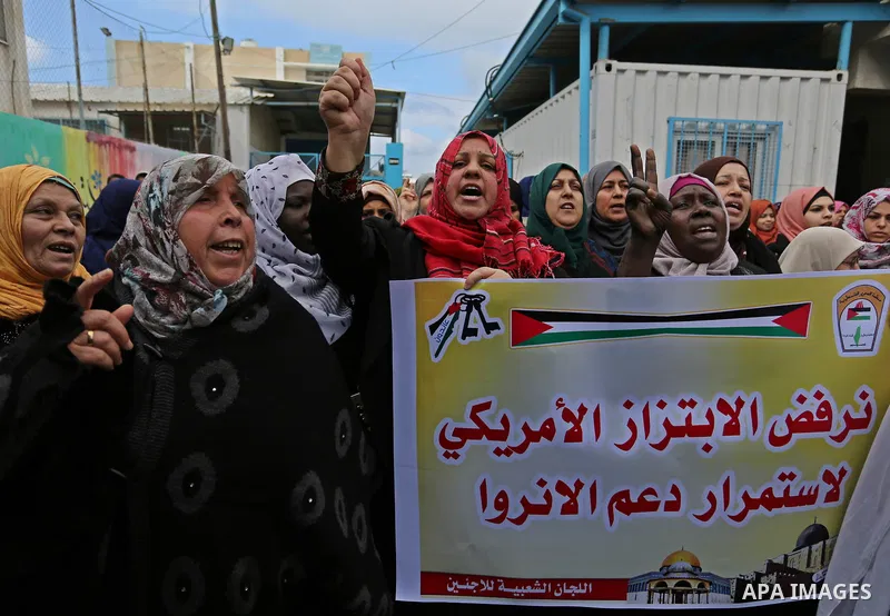 Palestinians take part in a protest against aid cut, in front of the headquarters United Nations Relief and Works Agency (UNRWA) in al-Nusirat refugee camp in the Gaza strip on January 17, 2018 after the White House froz...