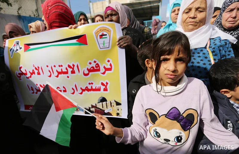 Palestinians take part in a protest against aid cut, in front of the headquarters United Nations Relief and Works Agency (UNRWA) in al-Nusirat refugee camp in the Gaza strip on January 17, 2018 after the White House froz...