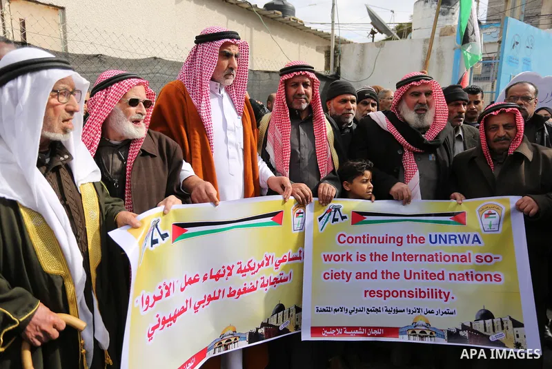 Palestinians take part in a protest against aid cut, in front of the headquarters United Nations Relief and Works Agency (UNRWA) in al-Nusirat refugee camp in the Gaza strip on January 17, 2018 after the White House froz...