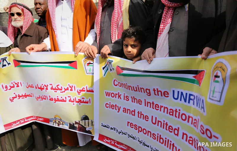 Palestinians take part in a protest against aid cut, in front of the headquarters United Nations Relief and Works Agency (UNRWA) in al-Nusirat refugee camp in the Gaza strip on January 17, 2018 after the White House froz...