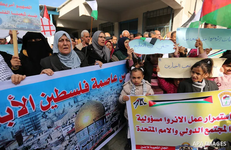 Palestinians take part in a protest against aid cut, in front of the headquarters United Nations Relief and Works Agency (UNRWA) in al-Nusirat refugee camp in the Gaza strip on January 17, 2018 after the White House froz...