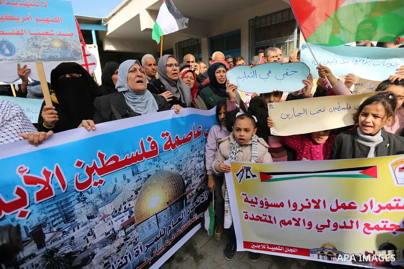 Palestinians take part in a protest against aid cut, in front of the headquarters United Nations Relief and Works Agency (UNRWA) in al-Nusirat refugee camp in the Gaza strip on January 17, 2018 after the White House froz...