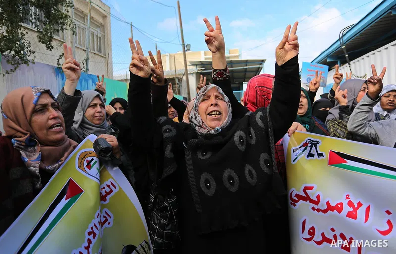 Palestinians take part in a protest against aid cut, in front of the headquarters United Nations Relief and Works Agency (UNRWA) in al-Nusirat refugee camp in the Gaza strip on January 17, 2018 after the White House froz...