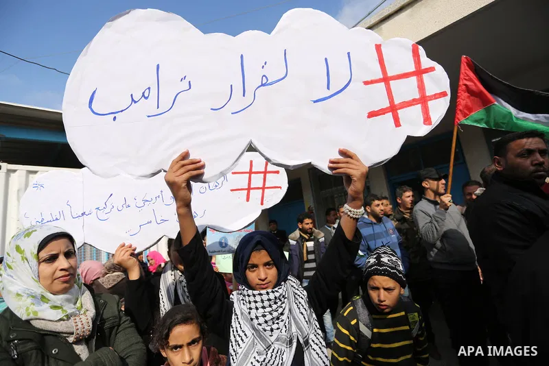 Palestinians take part in a protest against aid cut, in front of the headquarters United Nations Relief and Works Agency (UNRWA) in al-Nusirat refugee camp in the Gaza strip on January 17, 2018 after the White House froz...