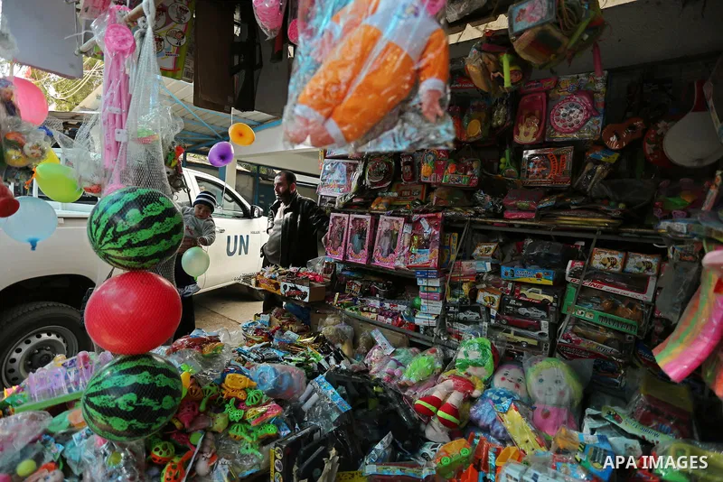 A Palestinian vendor sits at his store in al-Nusirat refugee camp in the Gaza strip on January 17, 2018. Gazans are strapped for cash and markets are suffering from an unprecedented recession. Meanwhile, on Dec. 30, for...