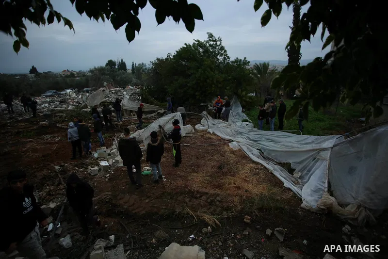 Palestinians stand on the rubble of the house of Palestinian gunman Ahmed Jarrar following an Israeli raid in the occupied West Bank, after it was demolished overnight on January 18, 2018 in Jenin. A Palestinian was kill...