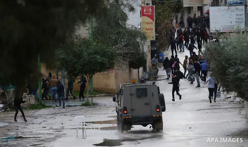 Israeli soldiers clash with Palestinians during a military operation in the West Bank city of Jenin on January 18, 2018. A Palestinian was killed during clashes with Israeli forces in the north of the occupied West Bank,...