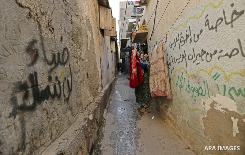 A Palestinian woman stands outside her house in al-Shati refugee camp in Gaza city on January 18, 2018. Photo by Ashraf Amra