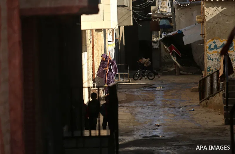 A Palestinian woman cleans outside her house in al-Shati refugee camp in Gaza city on January 18, 2018. Photo by Ashraf Amra