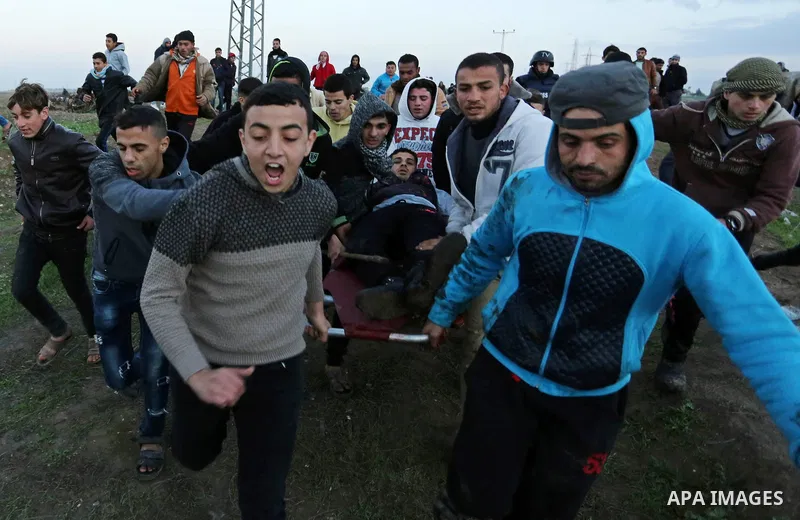 A wounded Palestinian protester is evacuated during clashes with Israeli security forces near the border with Israel in the east Gaza Strip, on January 19, 2018 as demonstrations continue over the US president's controve...