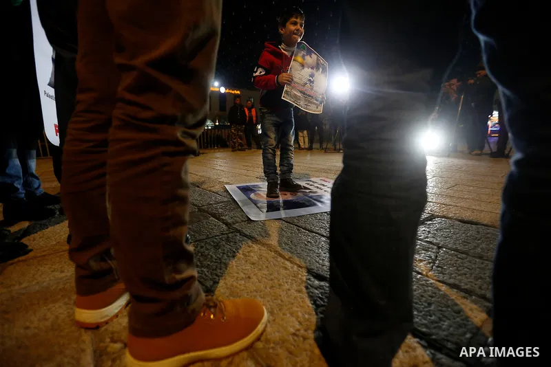 Palestinian protesters burn posters bearing portraits of US Vice President Mike Pence during a demonstration at the Manger Square in the town of Bethlehem in the occupied West Bank, on January 21, 2018. Pence arrived in...