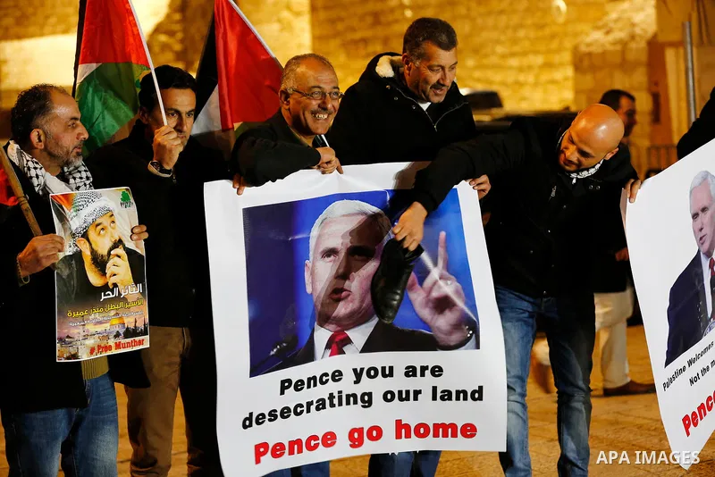 Palestinian protesters burn posters bearing portraits of US Vice President Mike Pence during a demonstration at the Manger Square in the town of Bethlehem in the occupied West Bank, on January 21, 2018. Pence arrived in...