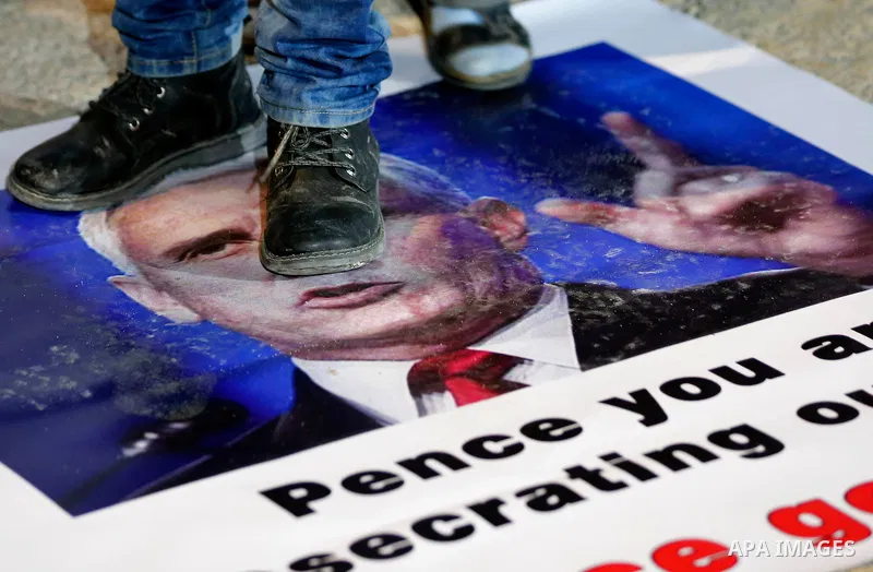 Palestinians hold posters bearing portraits of US Vice President Mike Pence during a protest at the Manger Square in the town of Bethlehem in the occupied West Bank, on January 21, 2018. Pence arrived in Israel for a vis...
