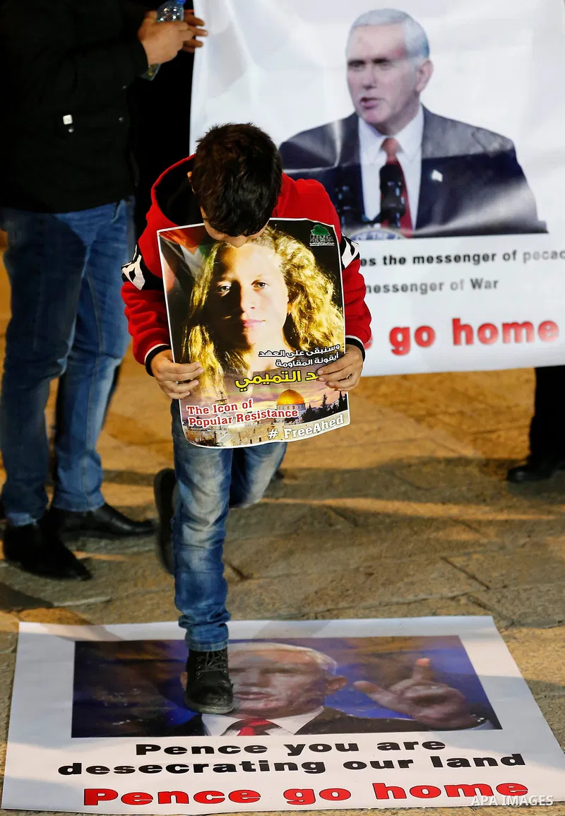 Palestinians hold posters bearing portraits of US Vice President Mike Pence during a protest at the Manger Square in the town of Bethlehem in the occupied West Bank, on January 21, 2018. Pence arrived in Israel for a vis...
