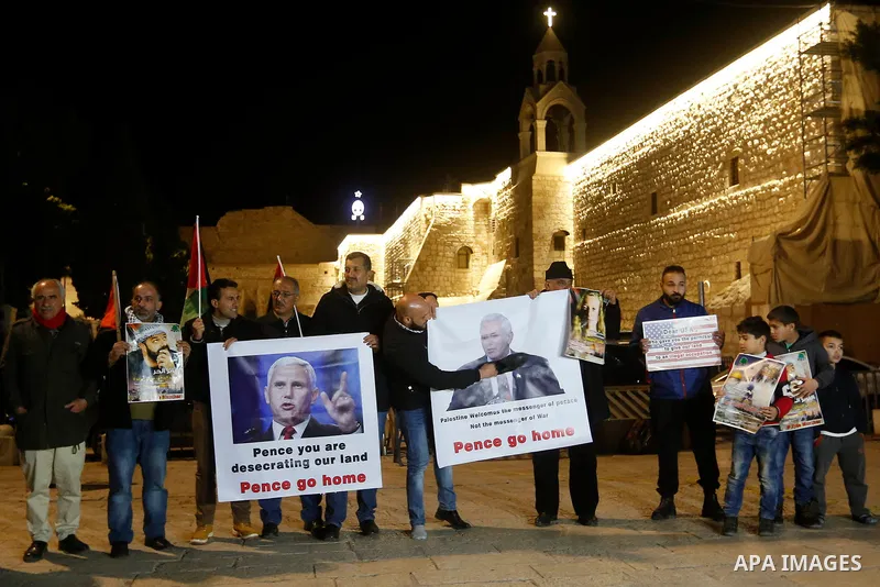 Palestinians hold posters bearing portraits of US Vice President Mike Pence during a protest at the Manger Square in the town of Bethlehem in the occupied West Bank, on January 21, 2018. Pence arrived in Israel for a vis...