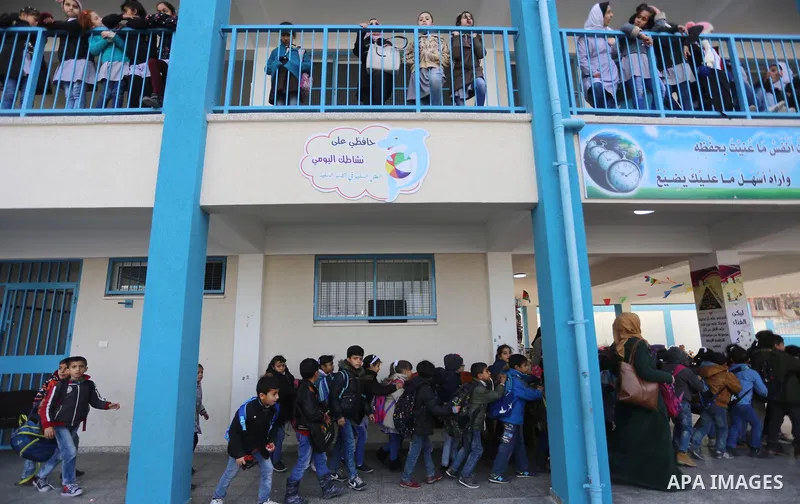 Palestinian schoolgirls pose for a group picture outside their classrooms at a school belonging to the United Nations Relief and Works Agency for Palestine Refugees (UNRWA) in Gaza City on January 22, 2018, during a visi...