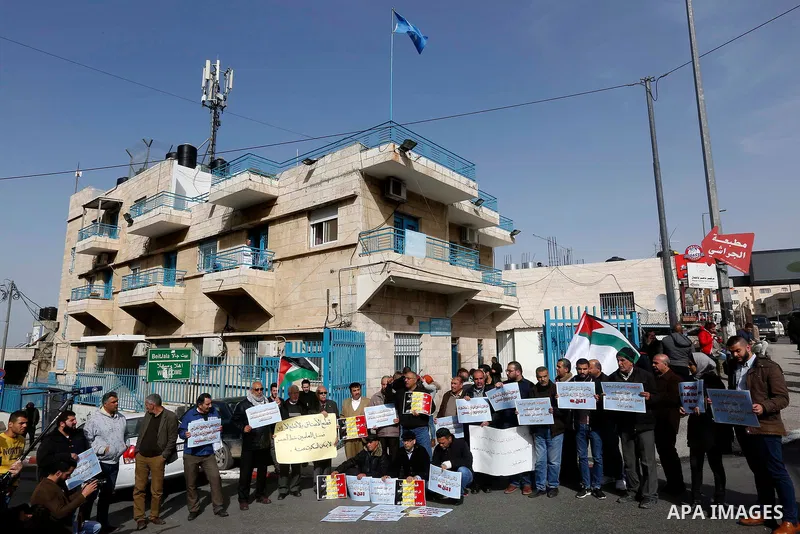 Palestinians take part in a protest in the town of Bethlehem in the occupied West Bank, on January 22, 2018 against freeze tens of millions of dollars in contributions to the United Nations Relief and Work Agency (UNRWA)...