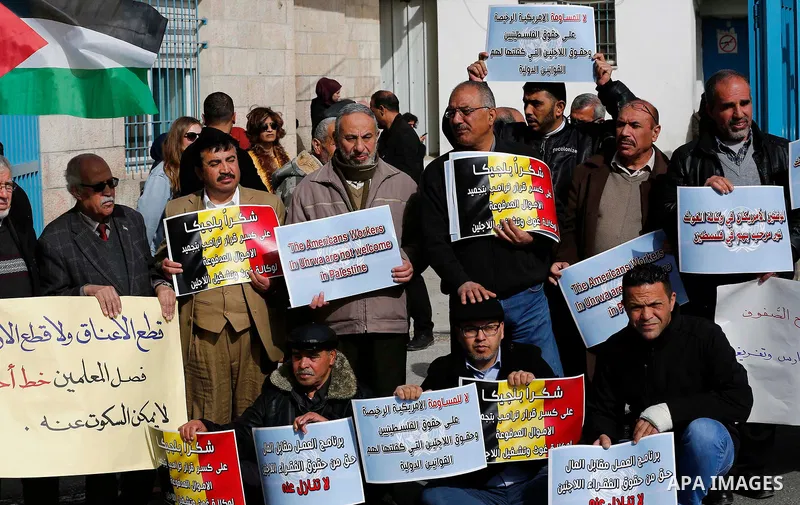 Palestinians take part in a protest in the town of Bethlehem in the occupied West Bank, on January 22, 2018 against freeze tens of millions of dollars in contributions to the United Nations Relief and Work Agency (UNRWA)...