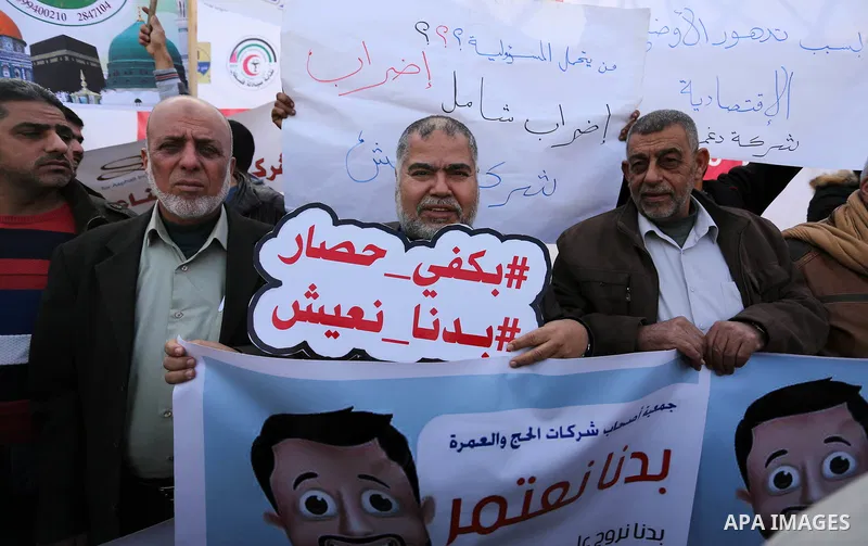 Palestinians take part in a protest against the siege on Gaza and the economic situation, in Gaza city on January 22, 2018. Photo by Ashraf Amra