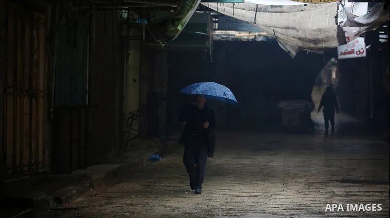 A picture taken on January 23, 2018 shows people walking past closed shops in an alley in the city of Nablus in the occupied West Bank, as people go on strike protesting against the visit of US Vice President Mike Pence...