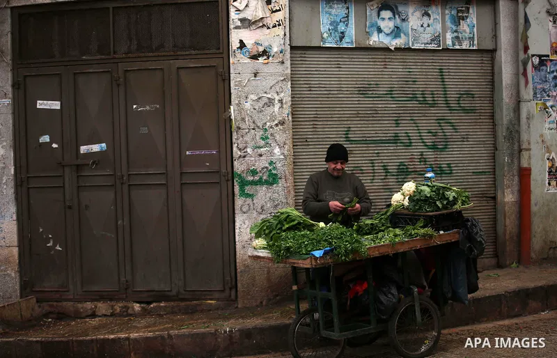 A picture taken on January 23, 2018 shows people walking past closed shops in an alley in the city of Nablus in the occupied West Bank, as people go on strike protesting against the visit of US Vice President Mike Pence...