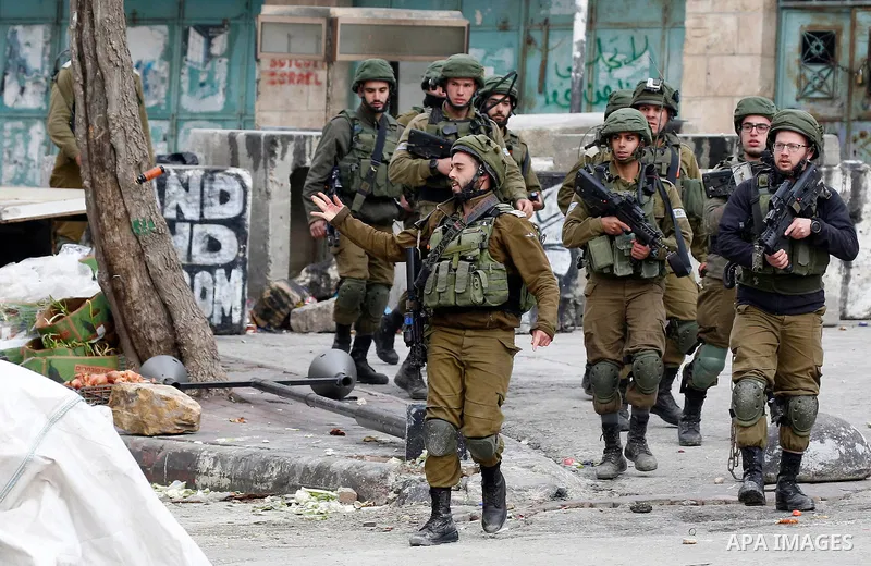 Israeli security forces take position during clashes with Palestinian protesters in the city of Hebron in the occupied West Bank, on January 23, 2018, as protests erupted following US Vice Presidents reaffirmation of US...