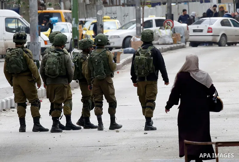 Israeli security forces take position during clashes with Palestinian protesters in the city of Hebron in the occupied West Bank, on January 23, 2018, as protests erupted following US Vice Presidents reaffirmation of US...