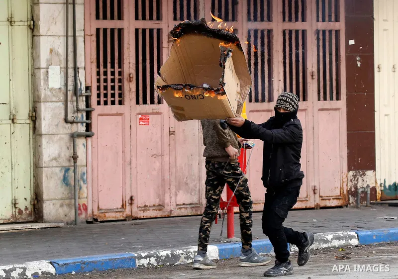 Palestinian protesters clash with Israeli security forces in the city of Hebron in the occupied West Bank, on January 23, 2018, as protests erupted following US Vice Presidents reaffirmation of US President Donald Trump'...