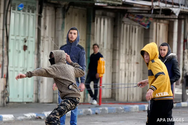 Palestinian protesters clash with Israeli security forces in the city of Hebron in the occupied West Bank, on January 23, 2018, as protests erupted following US Vice Presidents reaffirmation of US President Donald Trump'...