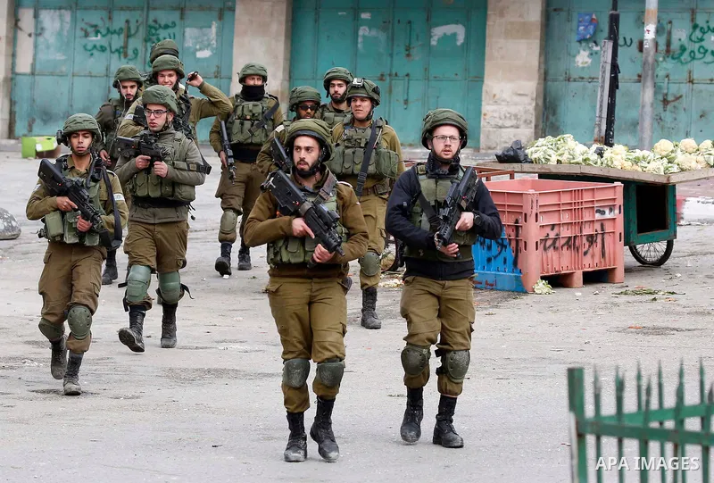 Israeli security forces take position during clashes with Palestinian protesters in the city of Hebron in the occupied West Bank, on January 23, 2018, as protests erupted following US Vice Presidents reaffirmation of US...