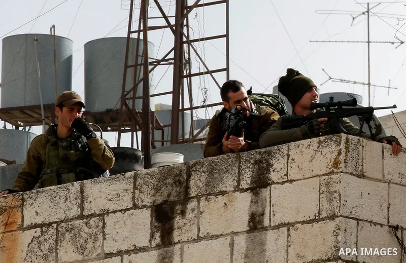 Israeli security forces take position during clashes with Palestinian protesters in the city of Hebron in the occupied West Bank, on January 23, 2018, as protests erupted following US Vice Presidents reaffirmation of US...