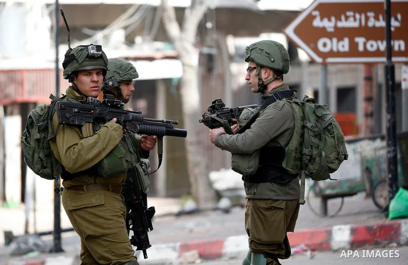 Israeli security forces take position during clashes with Palestinian protesters in the city of Hebron in the occupied West Bank, on January 23, 2018, as protests erupted following US Vice Presidents reaffirmation of US...