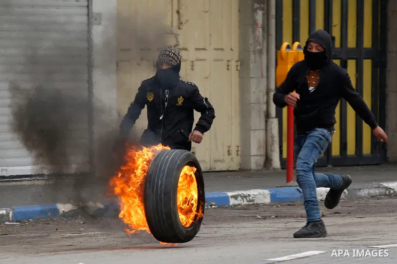 Palestinian protesters clash with Israeli security forces in the city of Hebron in the occupied West Bank, on January 23, 2018, as protests erupted following US Vice Presidents reaffirmation of US President Donald Trump'...