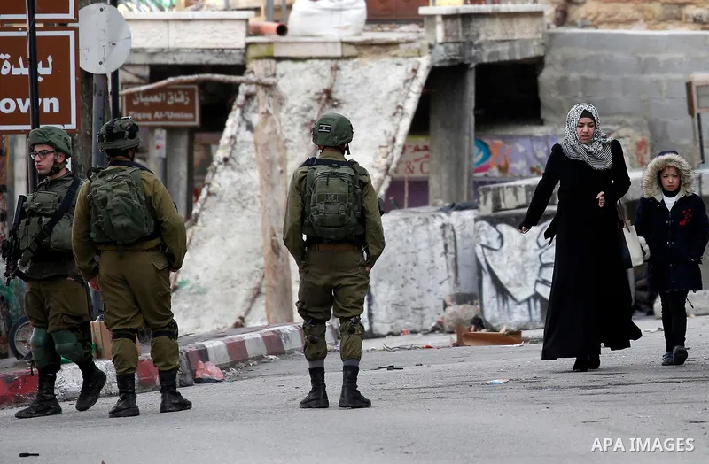 Israeli security forces take position during clashes with Palestinian protesters in the city of Hebron in the occupied West Bank, on January 23, 2018, as protests erupted following US Vice Presidents reaffirmation of US...