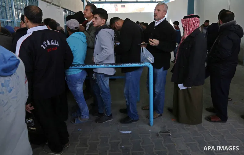 Palestinian refugees wait to receive aid at a United Nations food distribution center in Jabalia in the northern Gaza Strip on January 24, 2018. U.S. President Donald Trump is preparing to withhold tens of millions of do...
