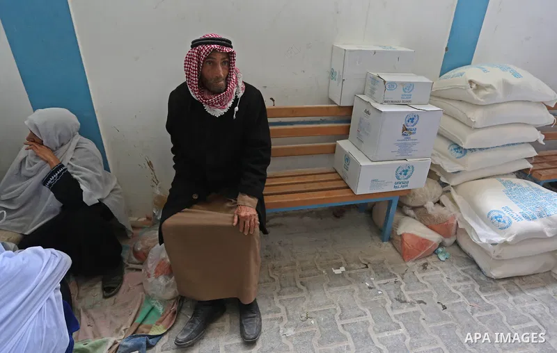 Palestinian refugees wait to receive aid at a United Nations food distribution center in Jabalia in the northern Gaza Strip on January 24, 2018. U.S. President Donald Trump is preparing to withhold tens of millions of do...