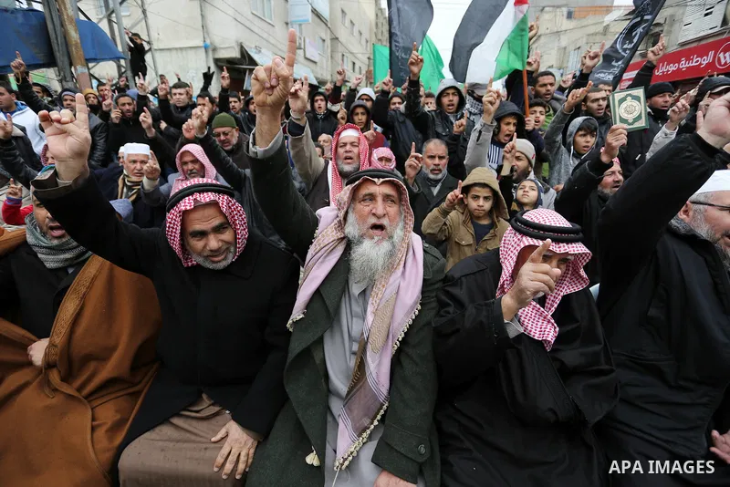 Palestinian supporters of Hamas movement take part during a protest against US President Donald Trump's decision to recognise Jerusalem as the capital of Israel, in Khan Younis in the southern Gaza Strip on January 26, 2...