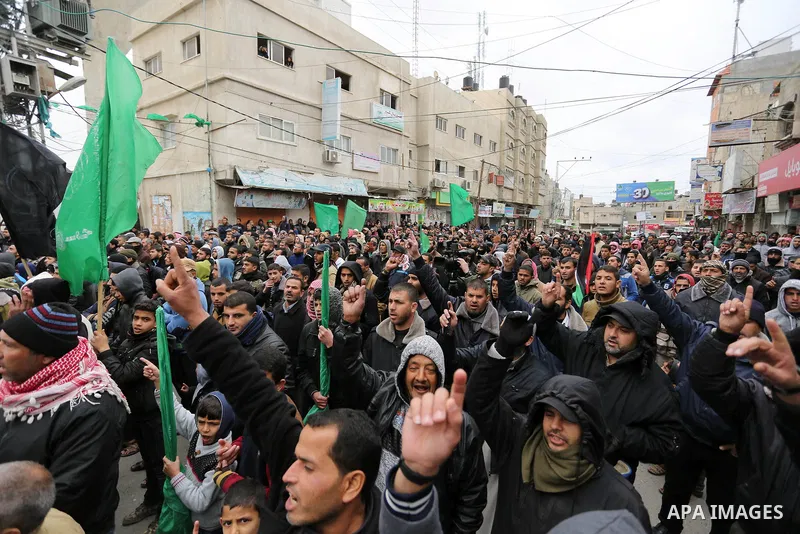 Palestinian supporters of Hamas movement take part during a protest against US President Donald Trump's decision to recognise Jerusalem as the capital of Israel, in Khan Younis in the southern Gaza Strip on January 26, 2...