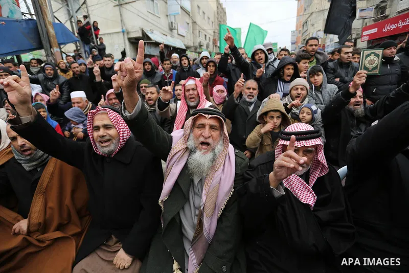 Palestinian supporters of Hamas movement take part during a protest against US President Donald Trump's decision to recognise Jerusalem as the capital of Israel, in Khan Younis in the southern Gaza Strip on January 26, 2...