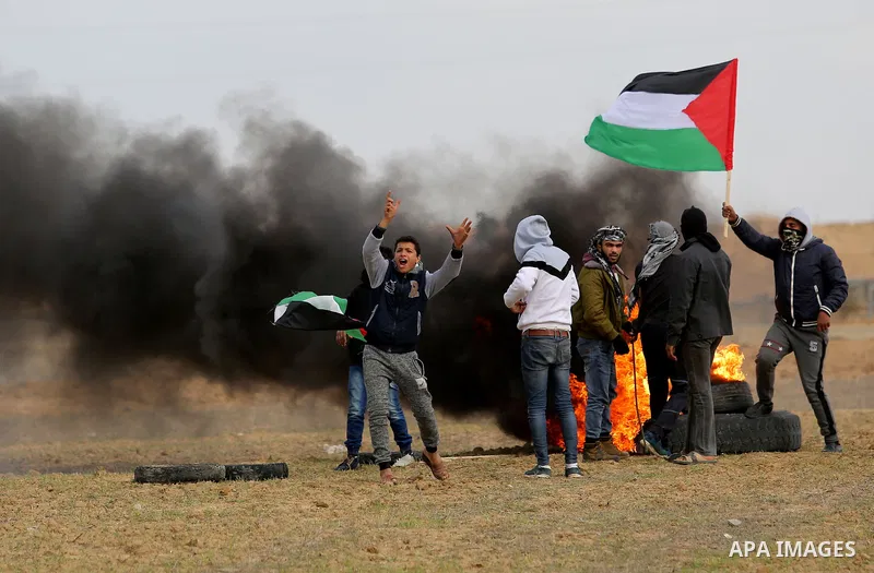 Palestinian protesters burn tires during clashes with Israeli security forces, as Palestinians call for 'a day of rage' against US President Donald Trump's decision to recognise Jerusalem as the capital of Israel, near t...