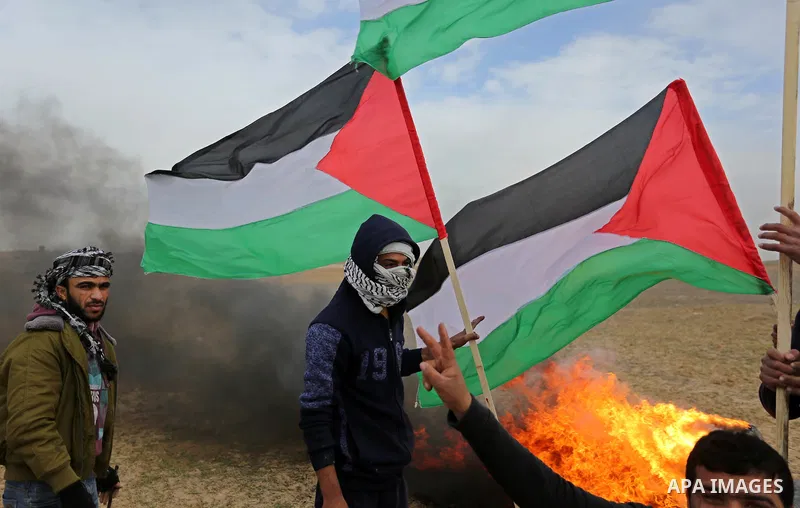 Palestinian protesters hold Palestinian flags during clashes with Israeli security forces, as Palestinians call for 'a day of rage' against US President Donald Trump's decision to recognise Jerusalem as the capital of Is...