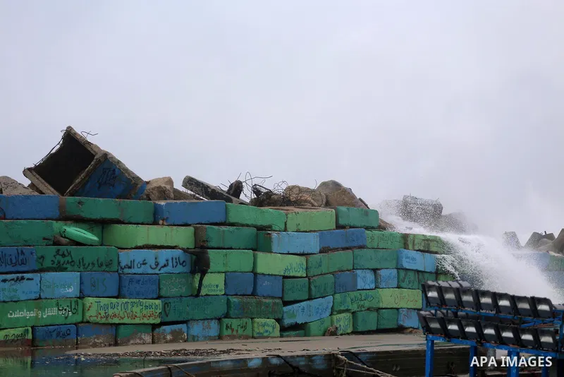 Waves break on the sea port in Gaza City during a rainy storm on January 27, 2018. Photo by Mohammed Asad