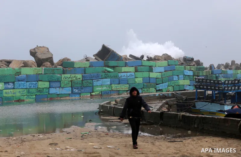 Waves break on the sea port in Gaza City during a rainy storm on January 27, 2018. Photo by Mohammed Asad