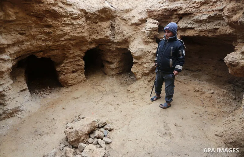 A Palestinians man stands at a freshly-discovered cemetery which was found by Abdelkarim al-Kafarna in his backyard in town of Beit Hanoun, in the northern Gaza strip on January 27, 2018. Experts said the graves were par...
