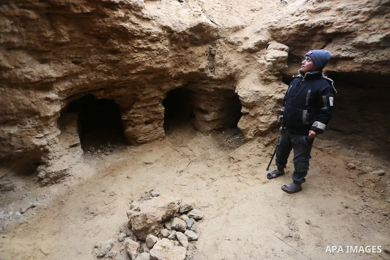 A Palestinians man stands at a freshly-discovered cemetery which was found by Abdelkarim al-Kafarna in his backyard in town of Beit Hanoun, in the northern Gaza strip on January 27, 2018. Experts said the graves were par...