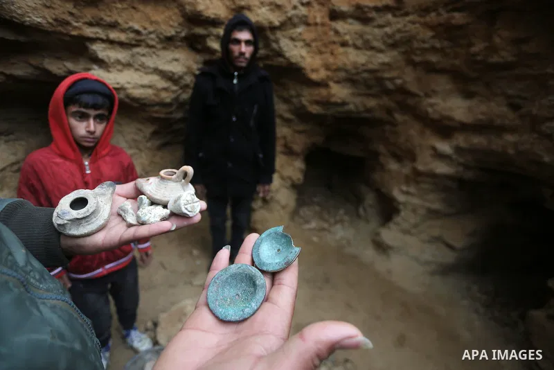A Palestinian man holds pottery fragments at a freshly-discovered cemetery which was found by Abdelkarim al-Kafarna in his backyard in town of Beit Hanoun, in the northern Gaza strip on January 27, 2018. Experts said the...