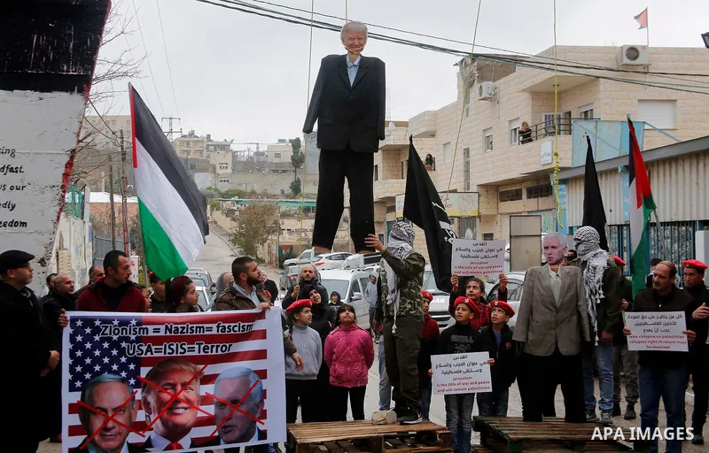 Palestinians hang a puppet bearing the portrait of US President Donald Trump, during a mock trial for him and Vice President Mike Pence in the Aida refugee camp in the West Bank city of Bethlehem on January 27, 2018. Pho...